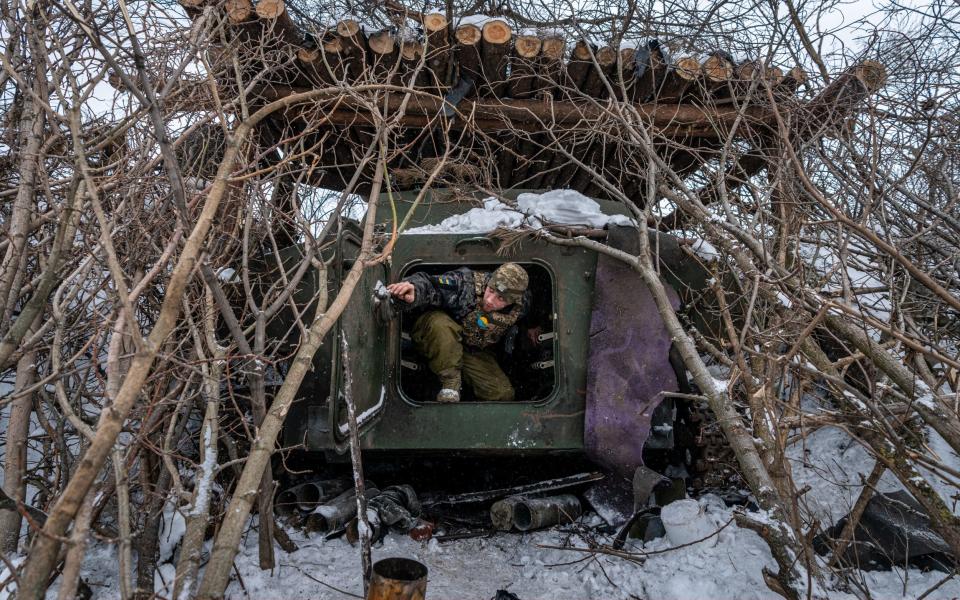 A Ukrainian soldier enters a self-propelled artillery vehicle in the Donetsk region