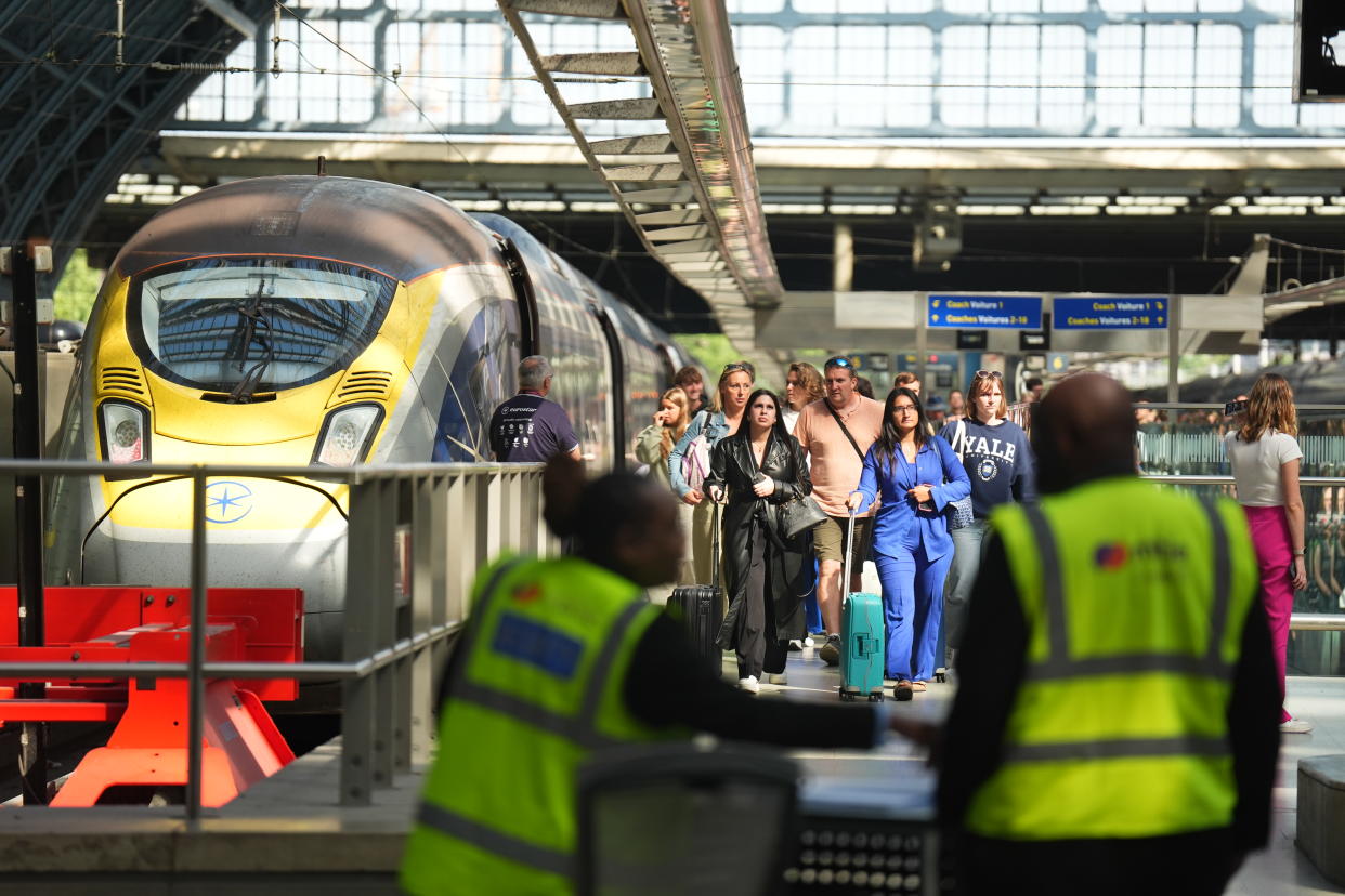 Passengers arrive by train at the Eurostar terminal at St Pancras station in central London. French rail officials say several lines have been hit by 