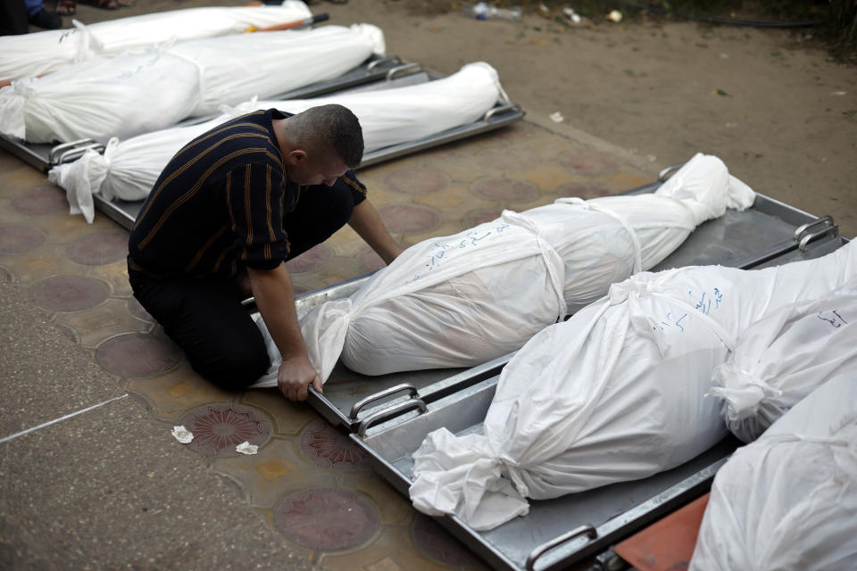 FILE - Palestinians mourn over the bodies of their relatives who were killed in Israeli bombardments, at the Nasser hospital in Khan Younis refugee camp, southern Gaza Strip, Monday, Dec. 4, 2023. In recent days, Israeli tanks have rumbled into southern Gaza, starting with Khan Younis. It marks a grim new chapter in the war that the Gaza Health Ministry says has already killed over 17,000 Palestinians and the U.N. estimates has displaced 1.9 million people. (AP Photo/Mohammed Dahman, File)