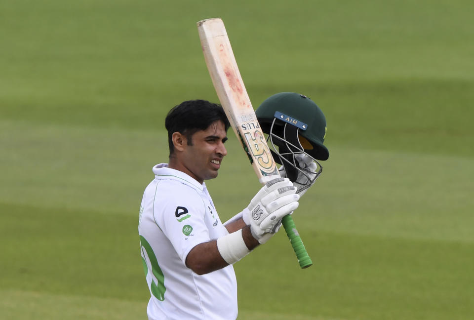 Pakistan's Abid Ali raises his bat to celebrate scoring fifty runs during the first day of the second cricket Test match between England and Pakistan, at the Ageas Bowl in Southampton, England, Thursday, Aug. 13, 2020. (Stu Forster/Pool via AP)