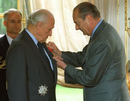 French President Jacques Chirac presents the Grand Officer of the Legion of Honour medal to the outgoing International Football Federation (FIFA) President Joao Havelange, during a ceremony at the Elysee Palace in Paris July 11, 1998. REUTERS/File photo
