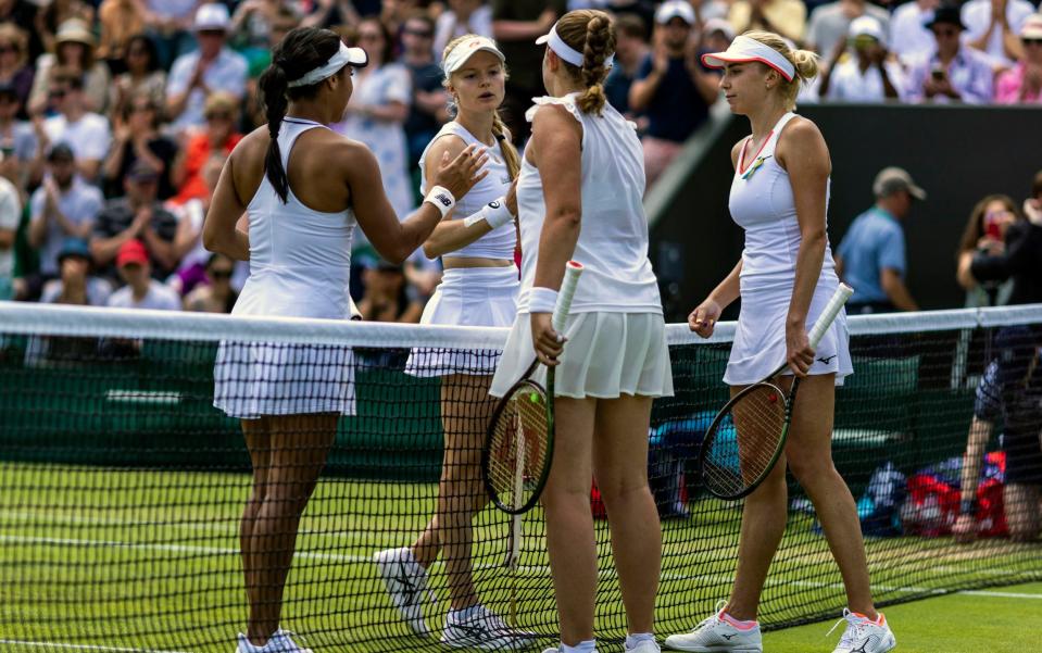 Harriet Dart and Heather Watson (left) congratulate Jelena Ostapenko and Lyudmyla Kichenok (right) - PA