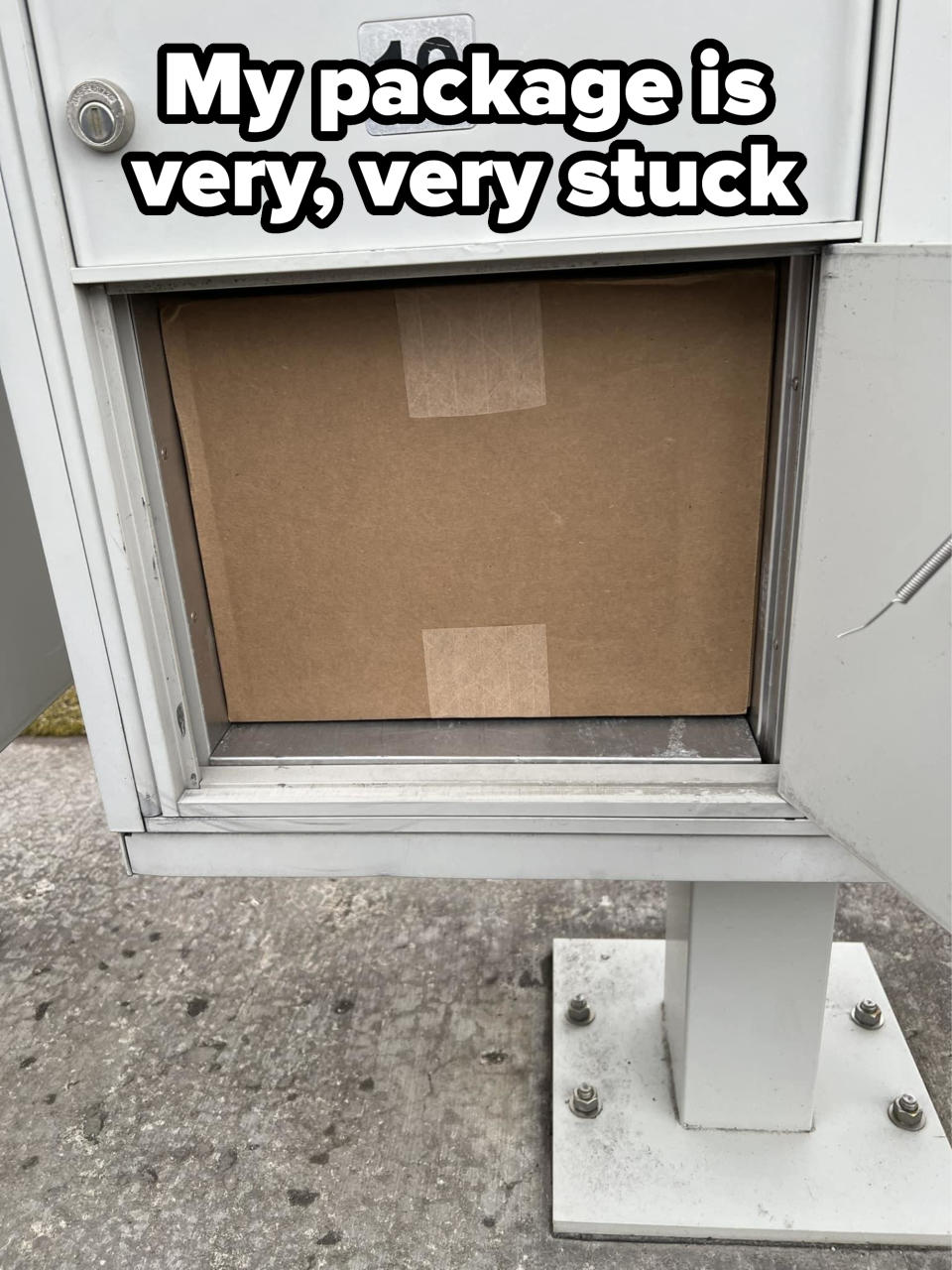 Package in a mailbox slot, secured with tape, visible through an open door