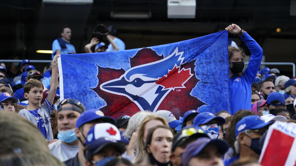 Jul 30, 2021; Toronto, Ontario, CAN; Toronto Blue Jays fans hold up a flag before the game against the Kansas City Royals at Rogers Centre. Mandatory Credit: John E. Sokolowski-USA TODAY Sports