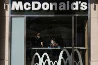 Cleaning ladies wearing protective face masks are seen inside a McDonald's restaurant, amid the spread of the coronavirus disease (COVID-19), in Athens