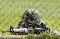 A Malaysian soldier secures the area as Malaysia's Defence Minister Ahmad Zahid Hamidi (not pictured) visits in Lahad Datu, near the location where suspected Philippine militants are holding off on March 4, 2013. Malaysia's government vows to beef up its security forces in an eastern state where nearly 30 people have been reported killed as police and soldiers grapple with a bizarre invasion by followers of a former Philippine sultanate. AFP PHOTO MALAYSIA OUT