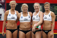 LONDON, ENGLAND - MAY 24: Members of Great Britain women's Beach Volleyball team (L-R) Denise Johns, Lucy Bolton, Shauna Mullin and Zara Dempne take part in a 'Stop Traffic' photocall on Parliament Square on May 24, 2012 in London, England. The PR stunt was aimed at reminding commuters that roads were likely to be busier at peak times during the 2012 London Olympic Games. (Photo by Dan Kitwood/Getty Images)