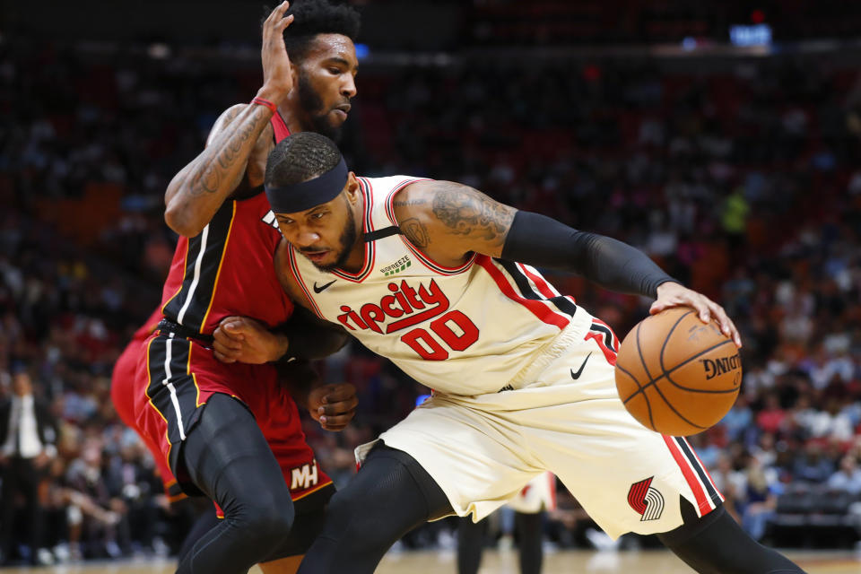 Portland Trail Blazers forward Carmelo Anthony (00) drives up against Miami Heat forward Derrick Jones Jr. during the first half of an NBA basketball game, Sunday, Jan. 5, 2020, in Miami. (AP Photo/Wilfredo Lee)