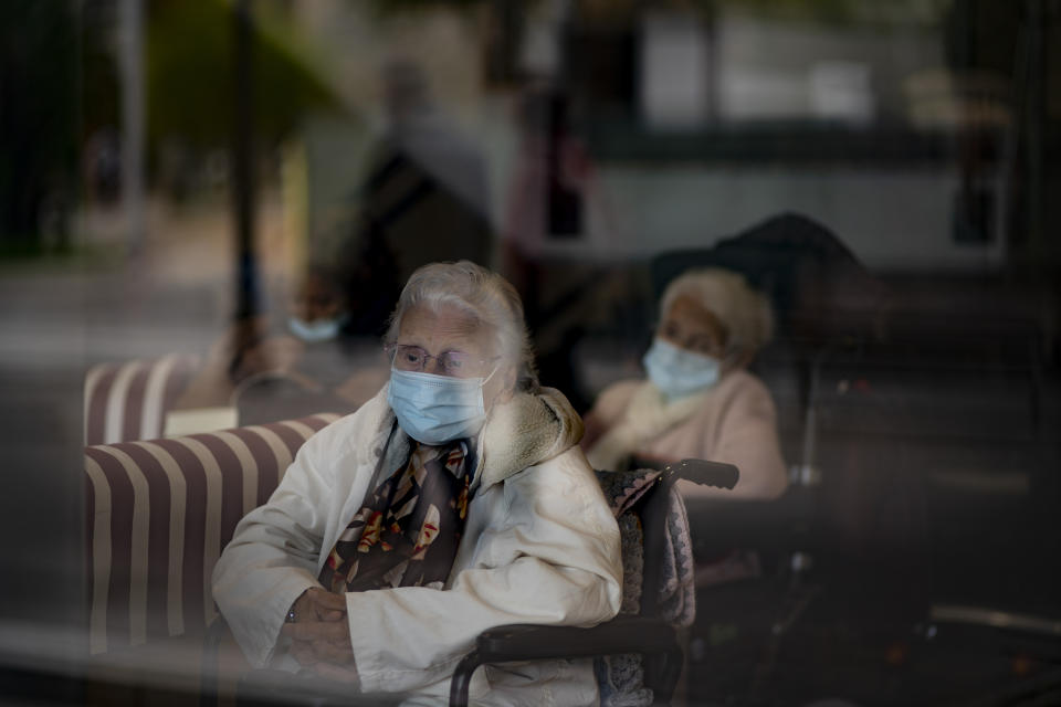 Residents look at the street through a window at the Icaria nursing home in Barcelona, Spain, Nov. 25, 2020. The image was part of a series by Associated Press photographer Emilio Morenatti that won the 2021 Pulitzer Prize for feature photography. (AP Photo/Emilio Morenatti)