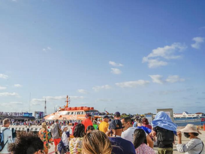 People waiting in line to ride a ferry.