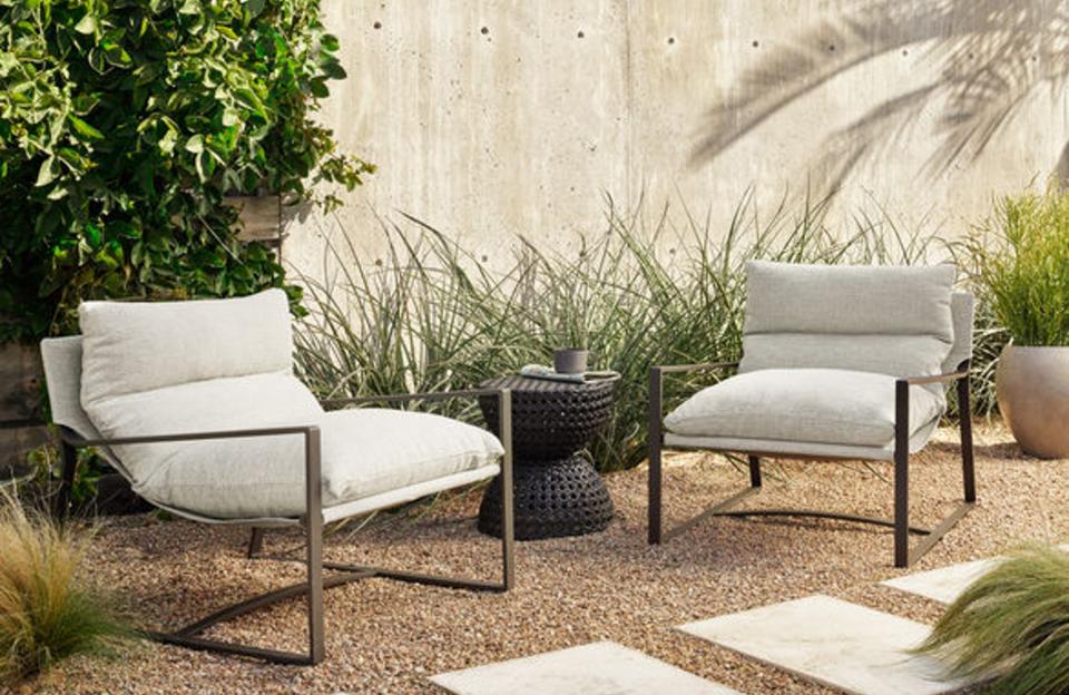 A pair of modern outdoor lounge chairs