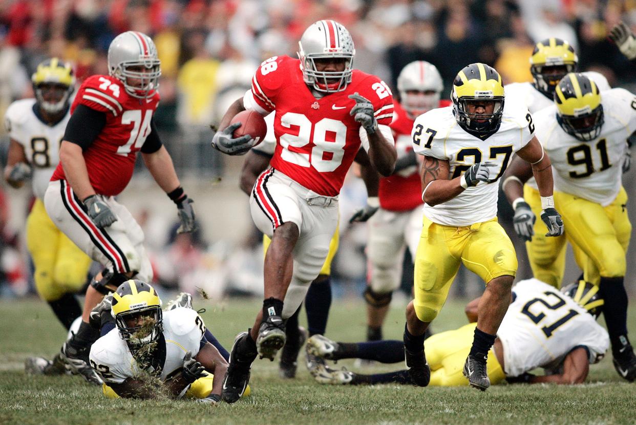2006-Ohio State 42, Michigan 39 
College football game of the century, Ohio State's Chris "Beanie" Wells (28) busts a 52 yd touchdown run against Michigan in 2006.