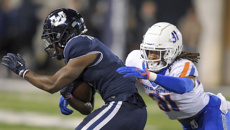 Utah State wide receiver Jalen Royals, left, gets tackled by Boise State safety Zion Washington (31) during the second half of an NCAA college football game Saturday, Nov. 18, 2023, in Logan, Utah. 