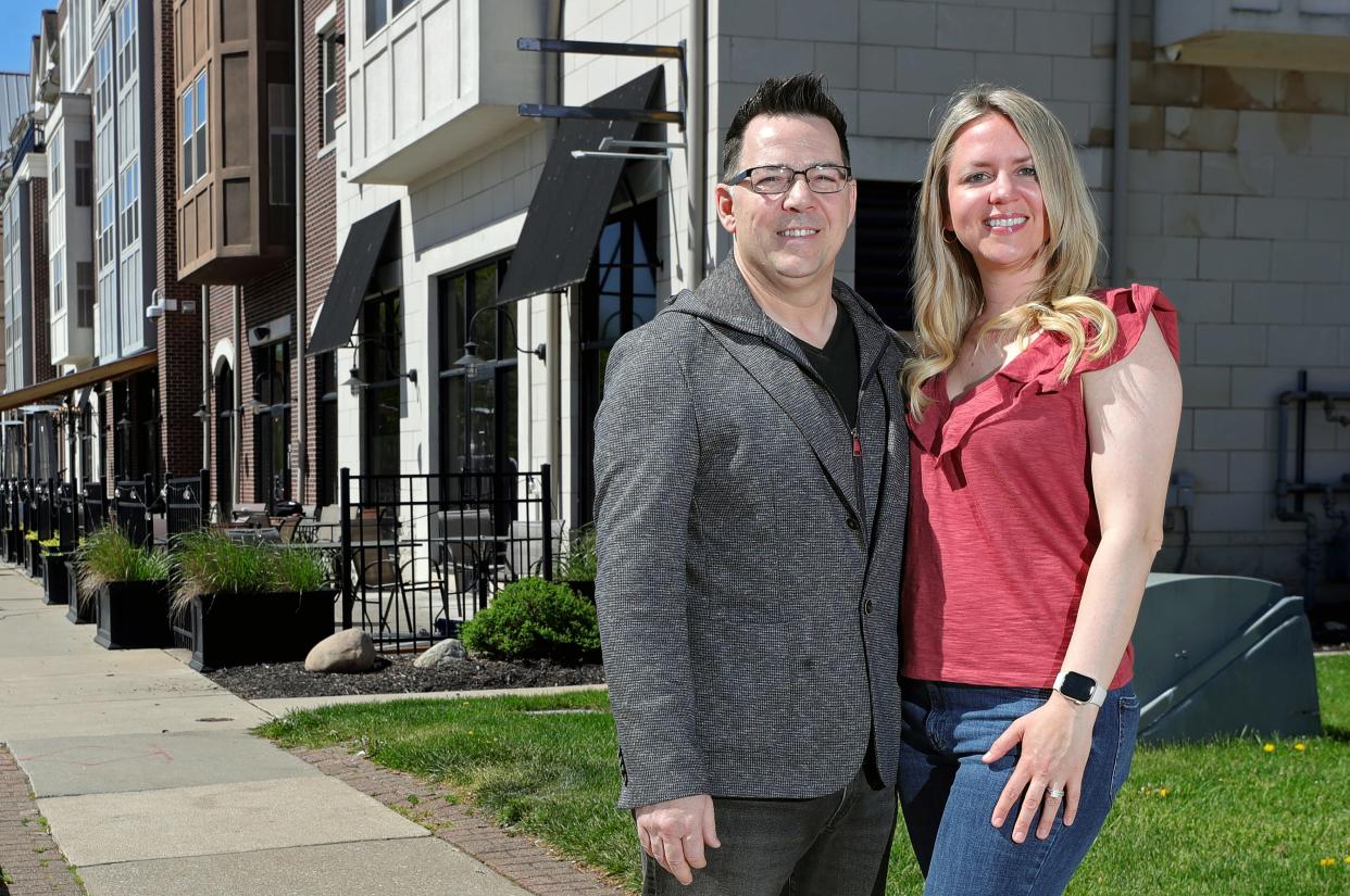 Joel and Cassie Testa of Testa Dining Group pose for a portrait outside the future home of Mattioli's Pizza and Oak & Olive speakeasy on Front Street, Thursday, May 2, 2024, in Cuyahoga Falls, Ohio.