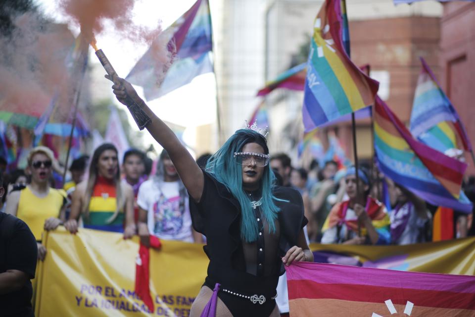 A trans woman holds a flare during the Gay Pride parade in Asuncion, Paraguay, Saturday, June 29, 2019. (AP Photo/Jorge Saenz)