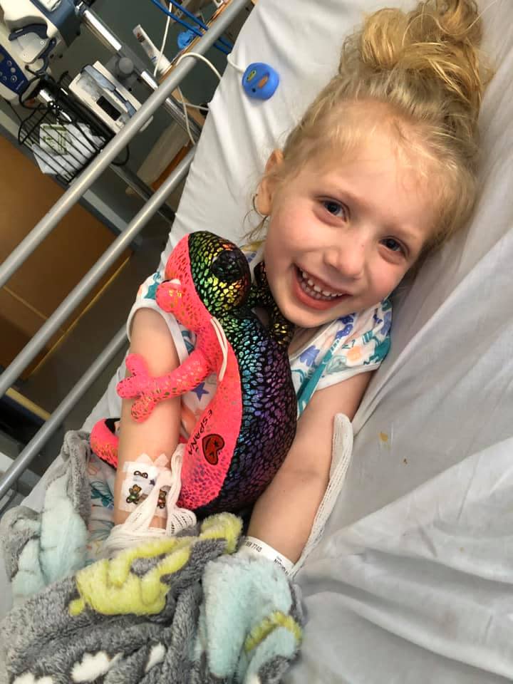 Pictured is Scarlett laying in her hospital bed smiling. Source: Twitter