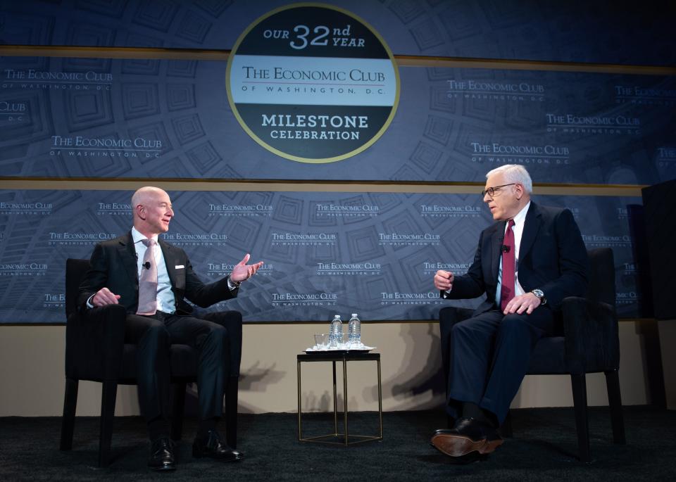 Jeff Bezos, founder and CEO of Amazon, speaks with US philanthropist David Rubenstein (R), during the Economic Club of Washington's Milestone Celebration event in Washington, DC, on September 13, 2018. (Photo by SAUL LOEB / AFP) (Photo by SAUL LOEB/AFP via Getty Images)