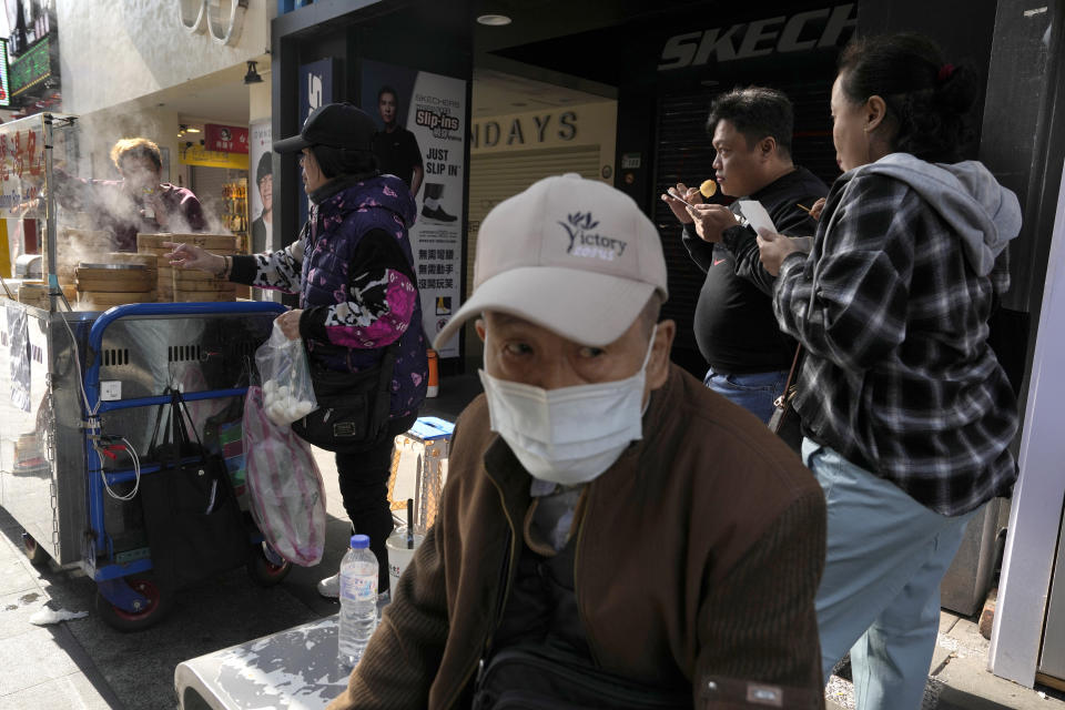A vendor sells dumplings along a retail street in Taipei, Taiwan, Thursday, Jan. 11, 2024. Beijing's threats to use force to claim self-governed Taiwan aren't just about missiles and warships. Hard economic realities will be at play as voters head to the polls on Saturday, though the relationship is complicated. (AP Photo/Ng Han Guan)