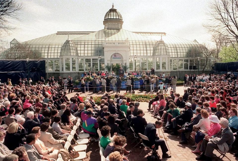 FILE -- Columbus, Ohio -- 1992 -- Invited guests listen to President George H. Bush's remarks at the opening of AmeriFlora '92 in Franklin Park on Columbus' eastside on April 20, 1992. (Columbus Dispatch Photo by Michael Munden)  Franklin Park Conservatory is in the background.   George H.W. Bush in Columbus .