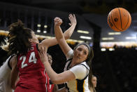 Georgia forward Brittney Smith (24) fights for a rebound with Iowa forward McKenna Warnock, right, in the first half of a second-round college basketball game in the NCAA Tournament, Sunday, March 19, 2023, in Iowa City, Iowa. (AP Photo/Charlie Neibergall)