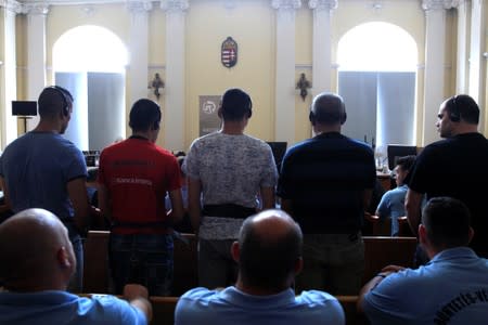 FILE PHOTO: Defendants stand in the court room, ahead of the trial in which they are charged with causing the death of 71 migrants who suffocated in a lorry found beside an Austrian motorway in 2015, in Kecskemet