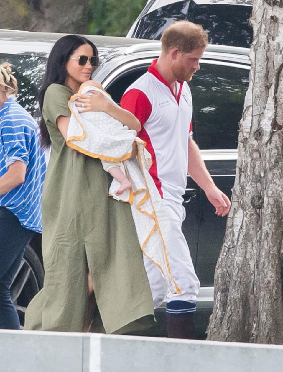 <p>Harry walks with Meghan and Archie after playing in a polo match in Wokingham, England. </p>