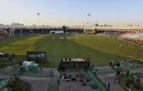 In this Monday, Feb. 17, 2020, photo, workers prepare stage for opening ceremony of Pakistan Super League at National stadium in Karachi, Pakistan. Security concerns stopped foreign cricketers from touring Pakistan four years ago when the country's premier domestic Twenty20 tournament was launched, forcing organizers to stage the event on neutral turf in the United Arab Emirates. When the 2020 edition of the PSL starts in Karachi on Thursday, Darren Sammy of the West Indies and Shane Watson of Australia will be among 36 foreign cricketers involved in the six franchises. (AP Photo/Fareed Khan)