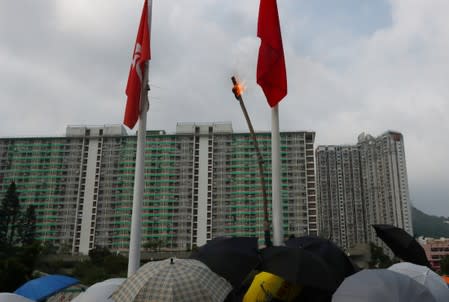 Anti-government protesters set up a fire on China's national flag at Wong Tai Sin district during a protest in Hong Kong