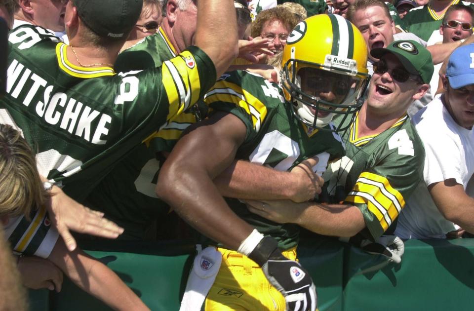 Green Bay Packers rookie wide receiver Javon Walker is embraced by fans after scoring his first NFL touchdown during the third quarter of their game Sunday, September 8, 2002 at Lambeau Field in Green Bay, Wis.(Milwaukee Journal Sentinel photo by Ernie Mastroianni)