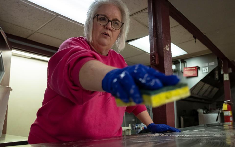 Tammy Lisby cleans a table in the concession stand during a volunteer clean-up on Saturday, April 2, 2022, at Indiana Central Little League in Indianapolis.