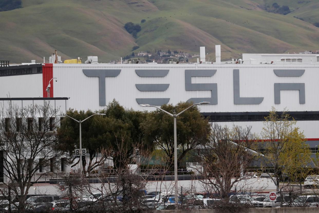 FILE PHOTO: The view of Tesla Inc's U.S. vehicle factory which was open for business on March 18, despite an order by the Alameda county's sheriff's office to comply with a three-week lockdown in the San Francisco Bay Area, in order to rein in the spread of coronavirus disease (COVID), in Fremont, California, U.S., March 18, 2020. REUTERS/Shannon Stapleton
