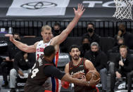 Portland Trail Blazers forward Norman Powell, front left, passes the ball around Detroit Pistons center Mason Plumlee, center, to center Enes Kanter during the second half of an NBA basketball game in Portland, Ore., Saturday, April 10, 2021. The Blazers won 118-103. (AP Photo/Steve Dykes)
