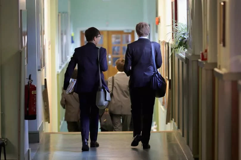 Two pupils walk down the corridor at Altrincham Grammar School for Boys, one of the country's best secondary schools -Credit:Getty Images