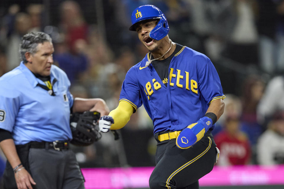 Seattle Mariners' Julio Rodriguez celebrates as scores on a double by Teoscar Hernandez against the Chicago White Sox during the fifth inning of a baseball game Friday, June 16, 2023, in Seattle. (AP Photo/John Froschauer)