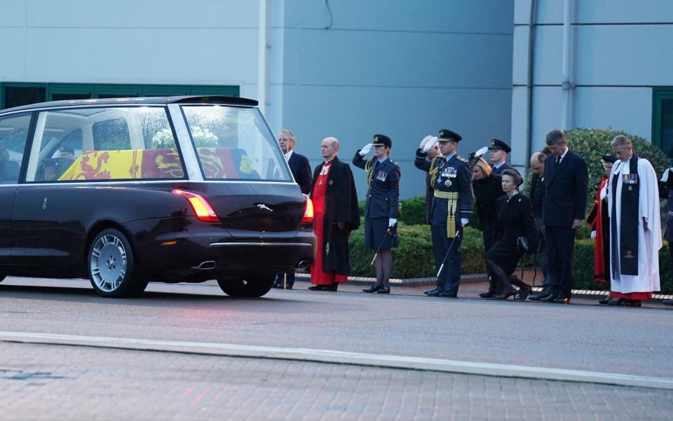 The Princess Royal curtsies as her mother's coffin is taken away in the State hearse from the Royal Air Force Northolt - Arthur Edwards/The Sun 