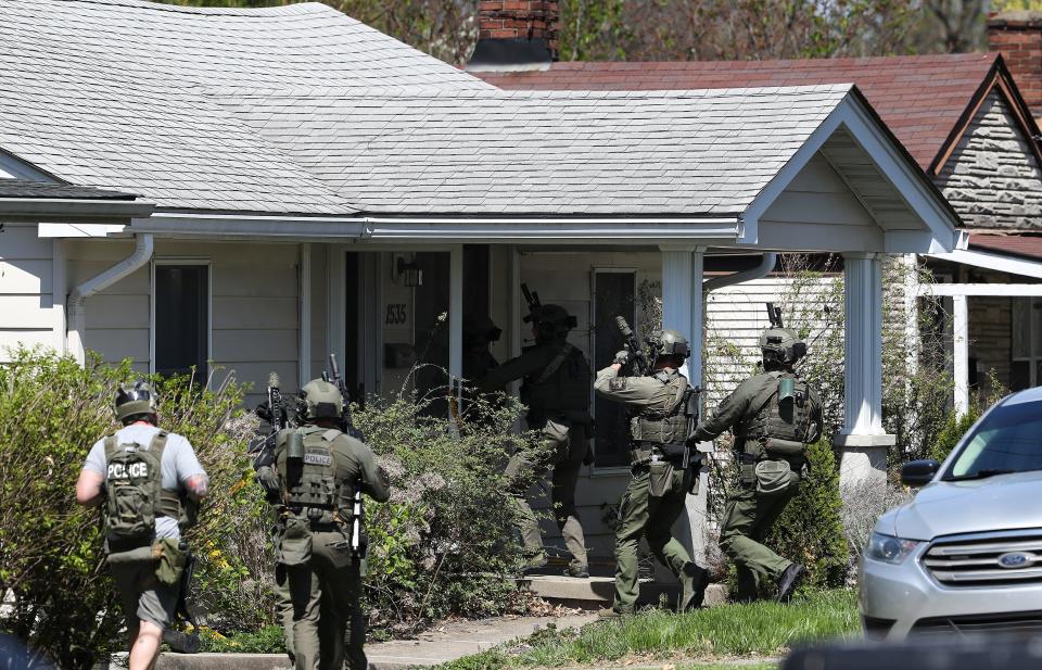 A SWAT unit enters 1535 Taylor Ave. during an investigation in the Camp Taylor neighborhood of Louisville, Ky. on Apr. 10, 2023.  