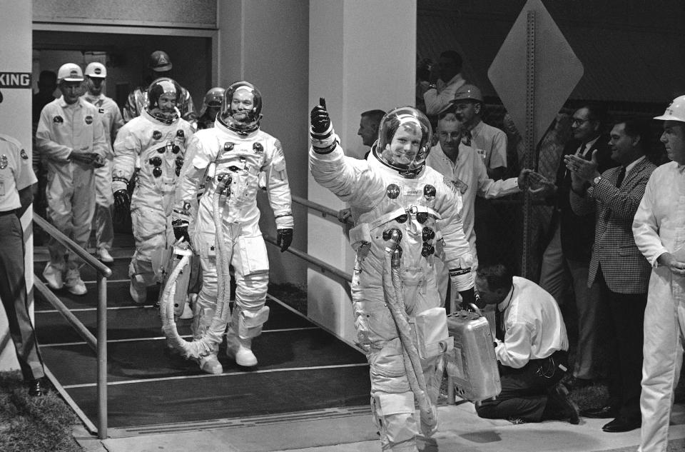 Apollo 11 astronauts Neil Armstrong, Michael Collins and Edwin Aldrin Jr. appeared in a cheerful mood as they left the Manned Spacecraft Operations Building to enter the transfer van that takes them to Pad 39 where they will enter their spacecraft looking forward to a moon landing, July 16, 1969, Cape Kennedy, Fla. (AP Photo)