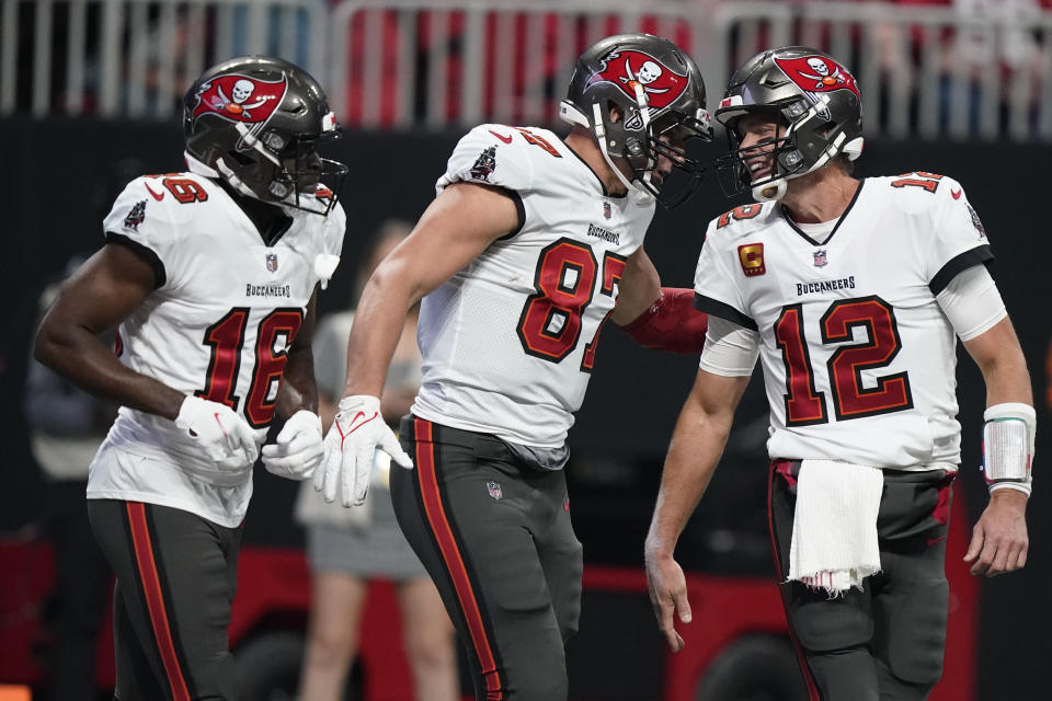 Tampa Bay Buccaneers tight end Rob Gronkowski (87) celebrates his touchdown with Tampa Bay Buccaneers quarterback Tom Brady (12) during the first half of an NFL football game against the Atlanta Falcons, Sunday, Dec. 5, 2021, in Atlanta. (AP Photo/Brynn Anderson)