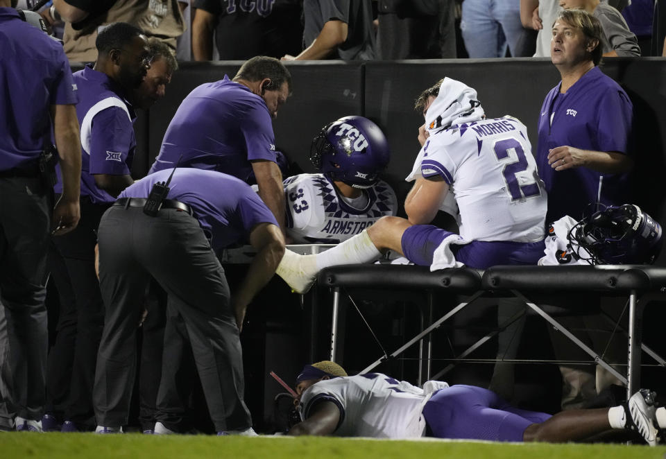 TCU quarterback Chandler Morris, right, is attended to by trainers after being injured while throwing a pass in the second half of an NCAA college football game against Colorado Friday, Sept. 2, 2022, in Boulder, Colo. (AP Photo/David Zalubowski)