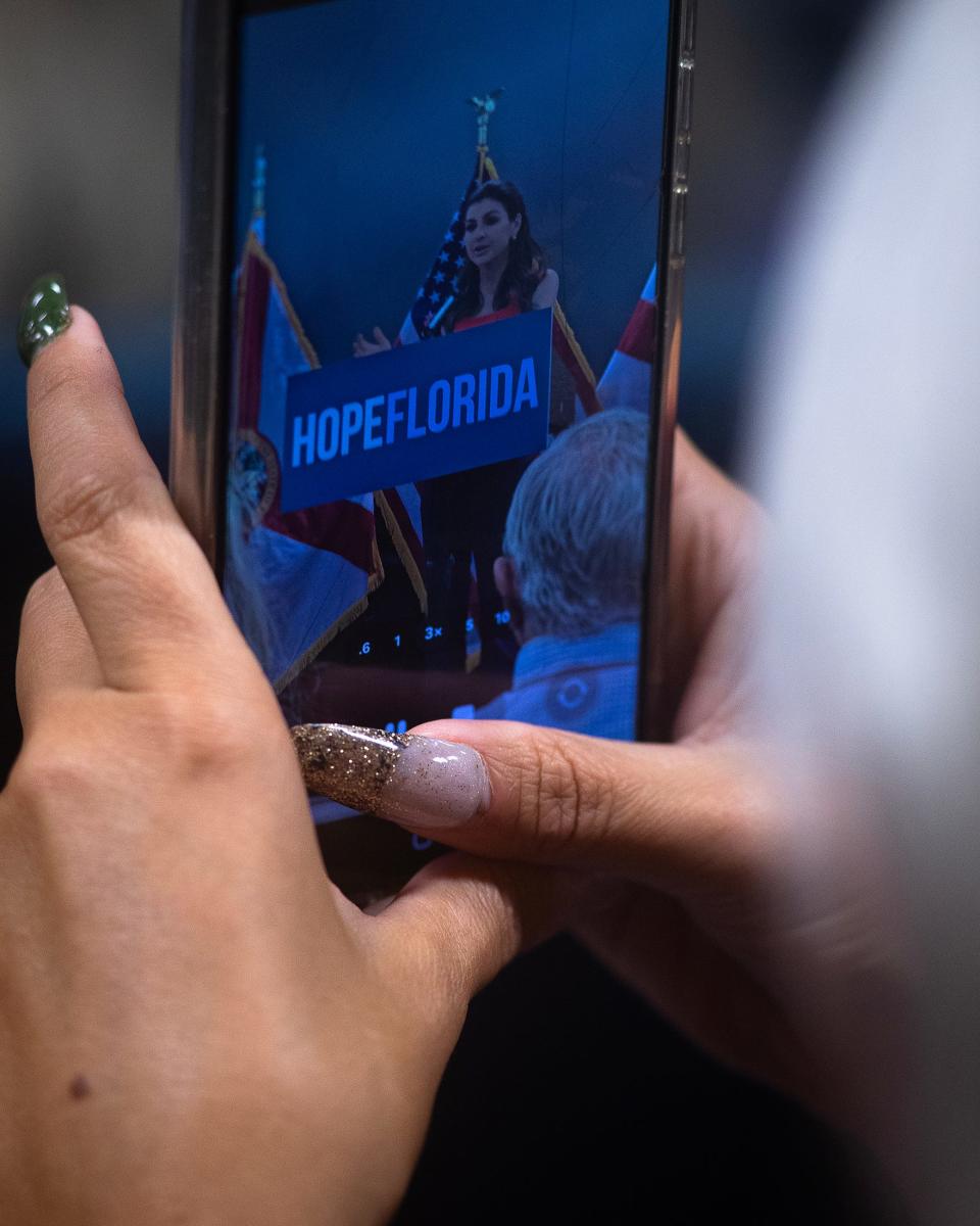 An attendee records Casey DeSantis on May 9 during a press conference about the "Hope Florida Fund" at Beachside Fellowship Miracle Center in Panama City Beach.