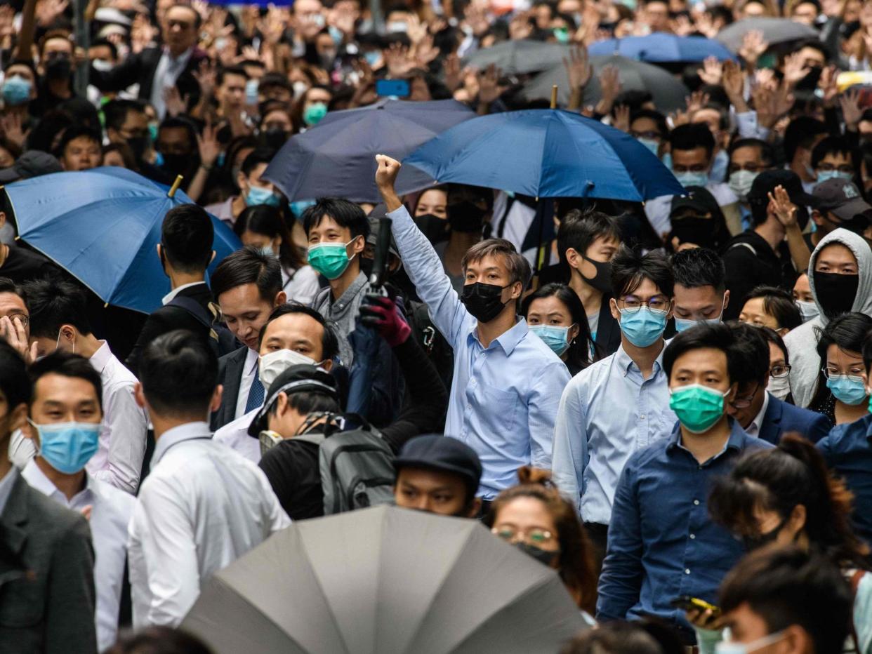 Office workers and pro-democracy protesters gather during a demonstration in Central in Hong Kong on Tuesday: AFP/Getty