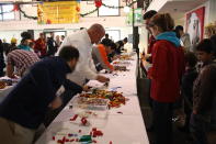 Judges examine the participants' models.