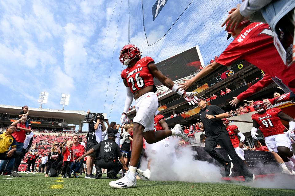 Louisville Cardinals safety M.J. Griffin (26) leads the team to the field before the first quarter against the South Florida Bulls at Cardinal Stadium on Sept. 24, 2022 in Louisville, Ky.