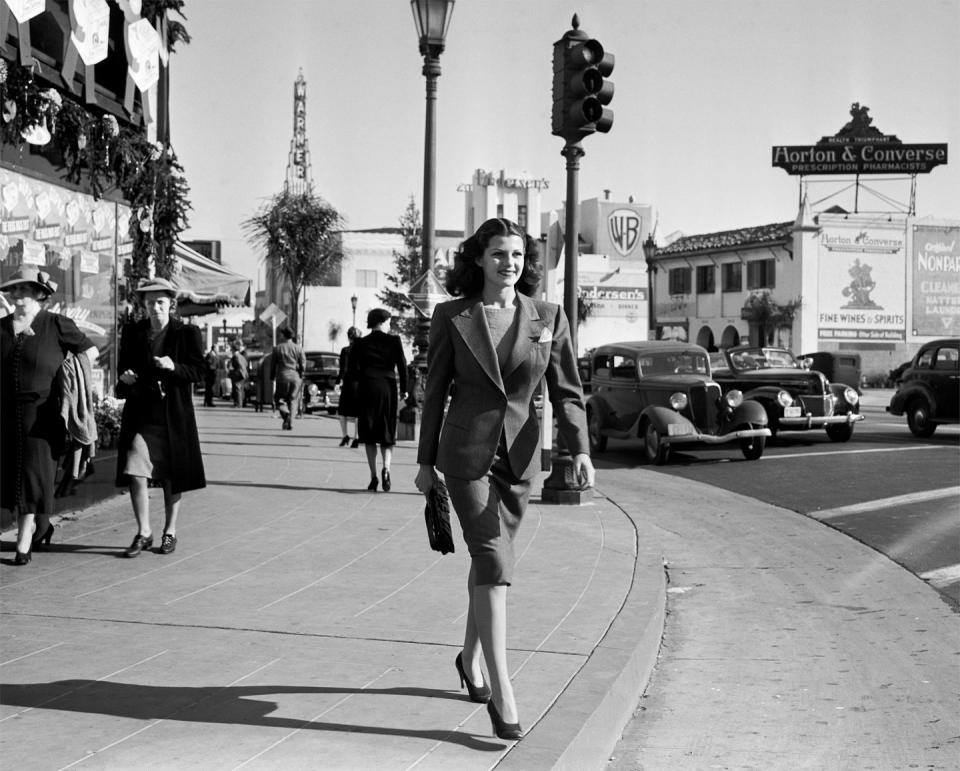 <p>An Old Hollywood icon, entertainer Rita Hayworth cruised down the street near Warner Bros. Studio in LA. At the time, she was married to Edward C. Judson, but that was her first of five marriages. </p><p><strong>RELATED: </strong><a href="https://www.goodhousekeeping.com/beauty/hair/g3471/most-popular-hairstyles-of-all-time/" rel="nofollow noopener" target="_blank" data-ylk="slk:The Trendiest Hairstyle the Year You Were Born;elm:context_link;itc:0;sec:content-canvas" class="link ">The Trendiest Hairstyle the Year You Were Born</a></p>