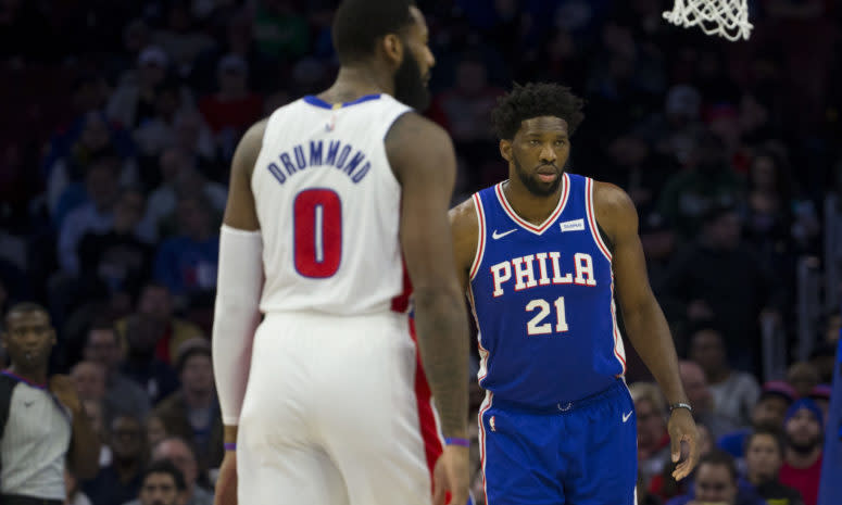 Joel Embiid looks for the ball with Andre Drummond defending.