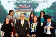 Philippines' Trade Secretary Ramon Lopez (2nd L, front) poses for a photo with his staff during the APEC Ministers Responsible For Trade (APEC MRT 23) meeting in Hanoi, Vietnam May 20, 2017. REUTERS/Kham