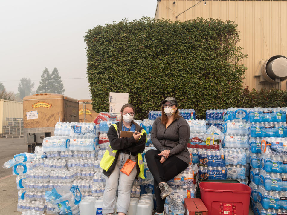 Kelsey Zimmer and Natalie Canida volunteer and coordinate relief efforts at the East Ave Church shelter. (Photo: Cayce Clifford for HuffPost)