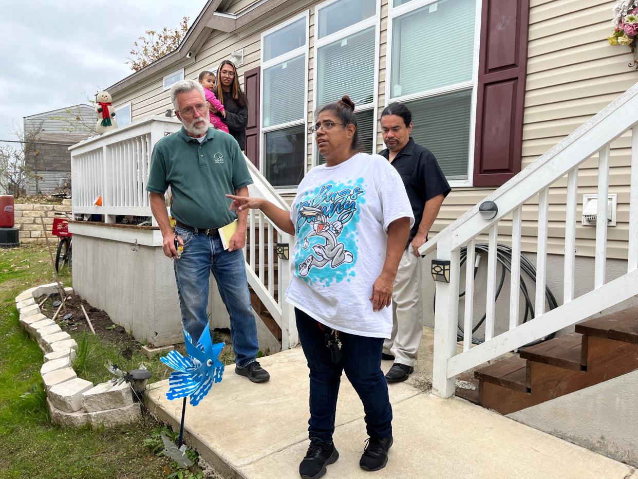 Danny Scott of CG&S Design-Build discusses the plan for a wheelchair ramp with Betty Patina Trujillo. While their biggest need will be taken care of, the Trujillo family still has many items on their Season for Caring wish list.