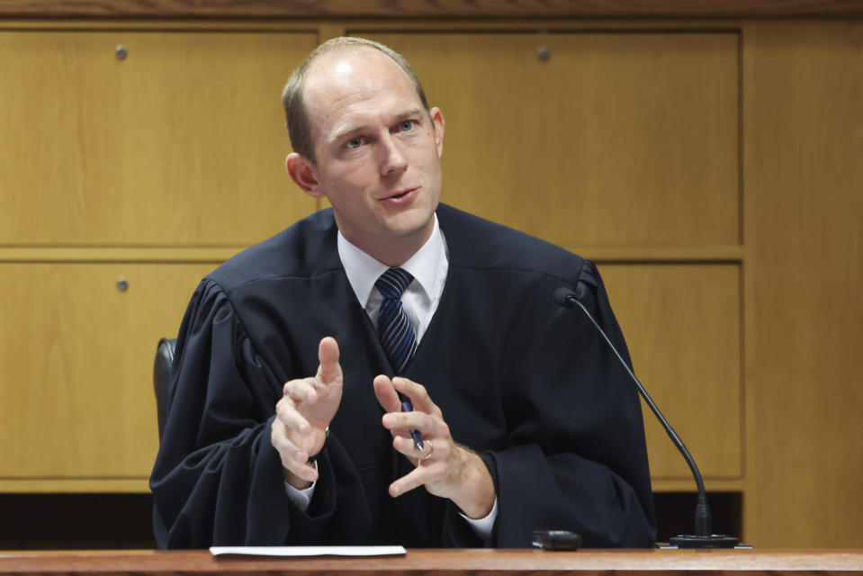 FILE - Fulton County Superior Judge Scott McAfee hears motions from attorneys representing Ken Chesebro and Sidney Powell in Atlanta on Wednesday, Sept. 6, 2023. Past high-profile trials suggest additional scrutiny and stress for the four judges overseeing the indictments against former President Donald Trump. But the challenge facing Fulton County Judge Scott McAfee in Georgia is unlike any of the others. (Jason Getz/Atlanta Journal-Constitution via AP, Pool, File)