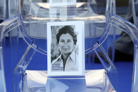 A photo is seen on an empty chair during a national tribute to late Auschwitz survivor and French health minister Simone Veil and her late husband Antoine Veil before being laid to rest in the crypt of the Pantheon mausoleum, in Paris, France, July 1, 2018. Ludovic Marin/Pool via Reuters